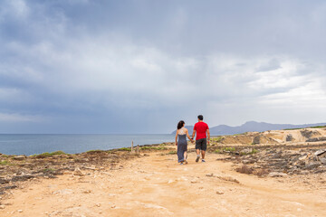 couple walking by the sea, Son Real, Santa Margarita, Majorca, Balearic Islands, Spain