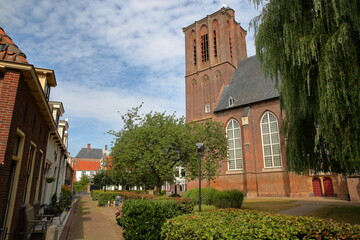 Fototapeta premium The historic Nicolaas church (Nicolaaskerk) in Elburg, Gelderland, Netherlands, viewed from Zuiderwalstraat street