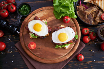 French toasts with fried eggs, cream cheese, salad and bacon