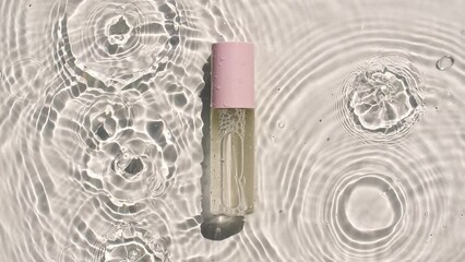 Cosmetic bottle, vial for oil, liquid, collagen serum on water surface with drops. Women's cosmetics skincare. Sample of layout of package beauty product. High quality 4k footage