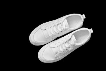 white sneakers isolated on a black background. Mock up. Sport shoes.
