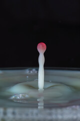 drops of wine over milk surface