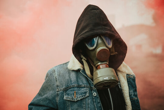 Person holding smoke bomb on street