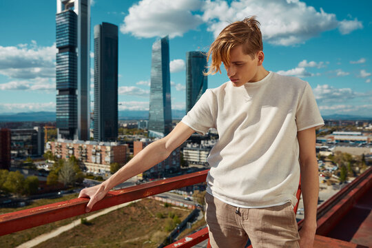 Young stylish man posing on street