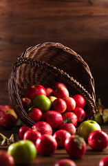 Apples are spilling out of the basket