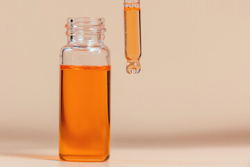 Pipette with a glass bottle on a light background.