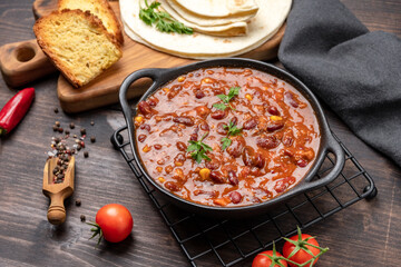 Bean and corn soup or ragout, red bean stew  on a wooden background. Food Protein Vegan dish