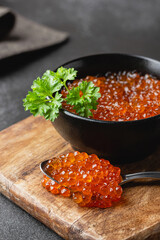 Red salmon caviar with parsley in a bowl