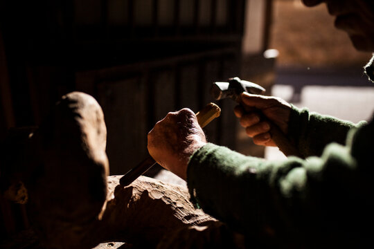 Elderly carpenter working with wood