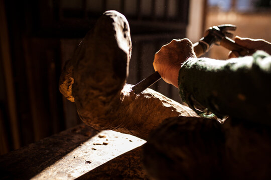 Elderly carpenter working with wood