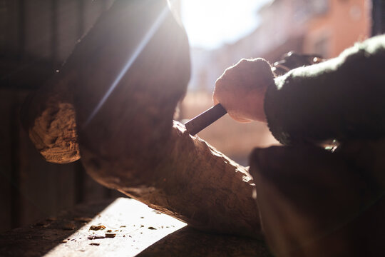 Elderly carpenter working with wood