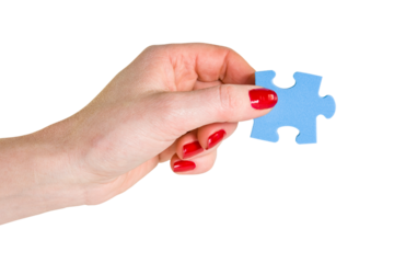 Female hand holding the missing blue piece of jigsaw puzzle