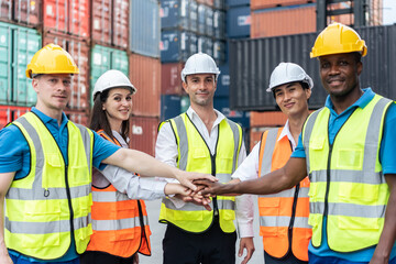 Group of man and woman worker put hand on each other in container port. - Powered by Adobe