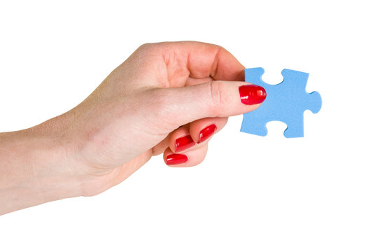 Female Hand Holding The Missing Blue Piece Of Jigsaw Puzzle