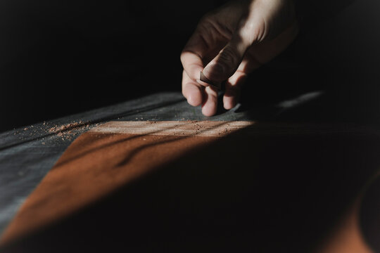 Man cutting textile in atelier