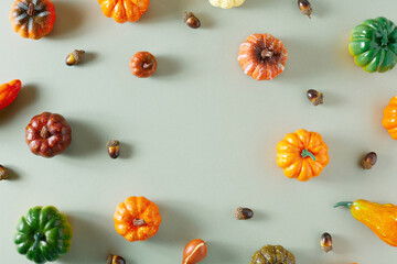 Creative flat lay autumn pattern made of colorful pumpkins on fall colors background with copy space. Modern aesthetic. Minimal seasonal concept.