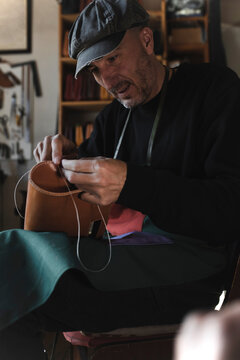 Man sewing textile in atelier
