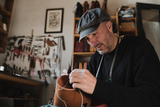 Man sewing textile in atelier
