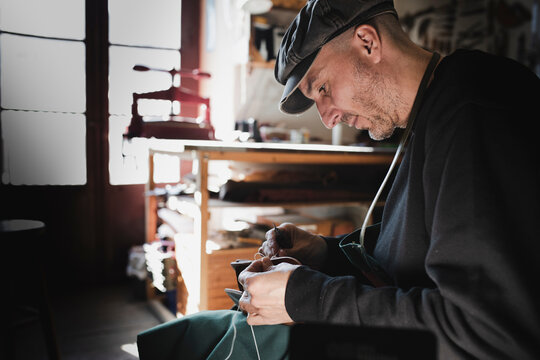 Man sewing textile in atelier