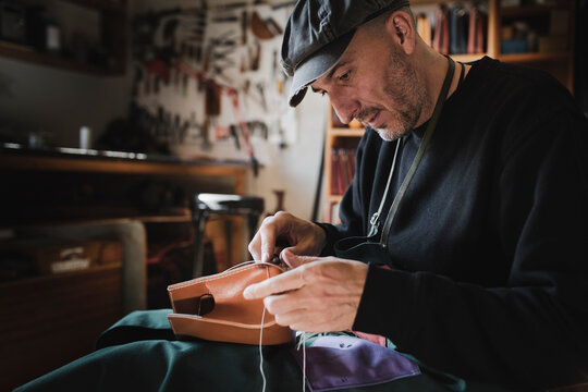 Man sewing textile in atelier