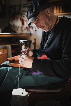 Man sewing textile in atelier