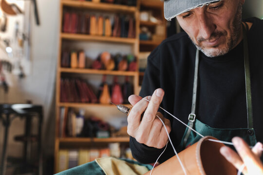 Man sewing textile in atelier