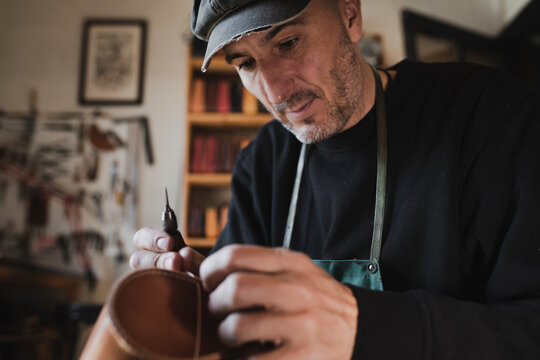 Man sewing textile in atelier