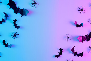 Creative layout with made of bats silhouettes and spiders in vibrant gradient holographic neon...