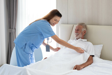 Fototapeta premium Nurse doctor senior care caregiver help assistence retirement home nursing elderly health. Elderly man with caregiver in nursing home. happy senior man. concept of caring for the elderly at home.