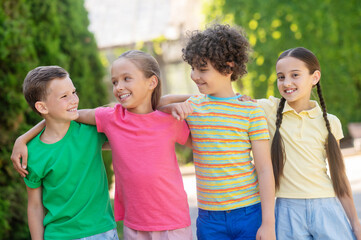 Smiling boys and girls standing hugging