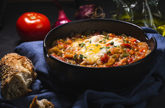 Tasty pisto with egg and vegetables in bowl