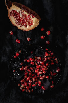 Fresh and red pomegranate on dark background