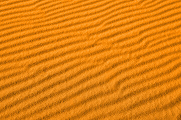 Closeup view of orange sand dune in desert as background