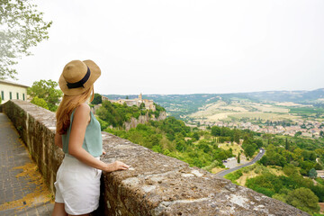 Traveler girl enjoying view of Umbria hills from Orvieto town, Italy - obrazy, fototapety, plakaty