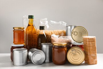 Different products on white wooden table. Food donation