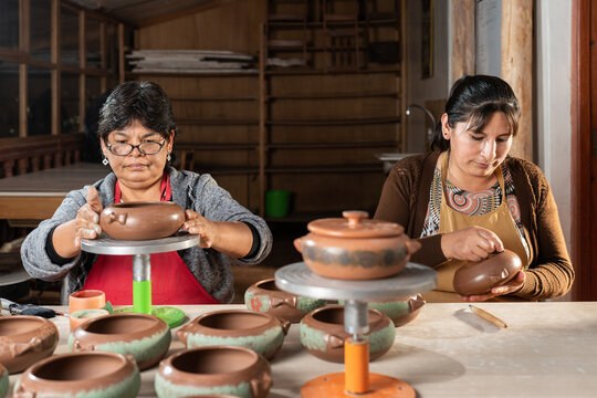 Peruvian women painting ceramic bowls