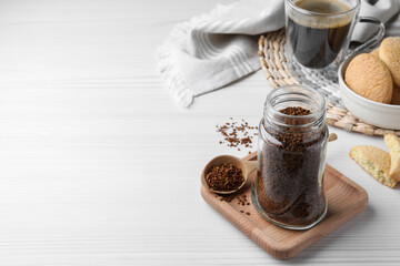 Jar of instant coffee and spoon on white wooden table. Space for text - obrazy, fototapety, plakaty