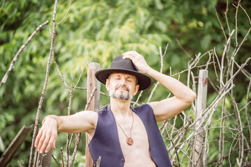 Man on a walk with a guitar and a hat