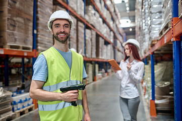 Joyous storehouse employee and a serious supervisor working together
