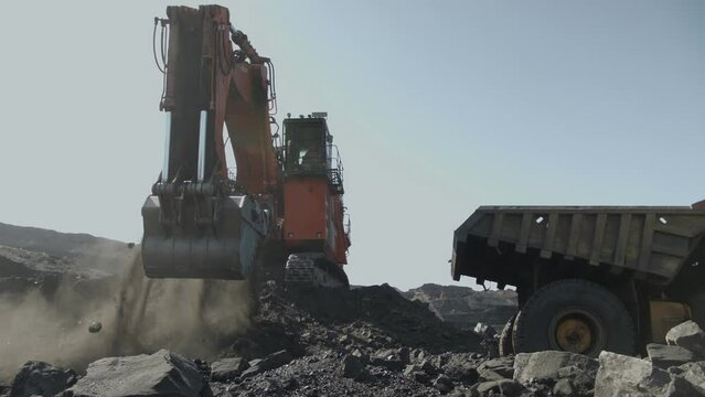 Work of excavator with Russian flag on coal deposit in Kemerovo. Mining industry in Russia
