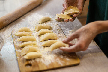 Traditional dish dumplings small pies with cottage cheese on a cutting board