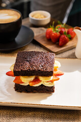 Banana and strawberry cake with coffee. Fruit dessert presentation.