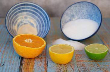 citrus and sugar still life on blue aged wooden table and gray background