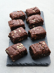 Homemade chocolate fudge brownie with almond topping, close up