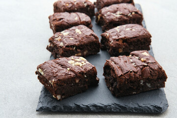 Homemade chocolate fudge brownie with almond topping, close up
