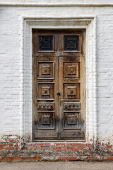 old wooden door against a white wall