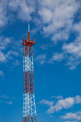 red mobile phone tower against the blue sky