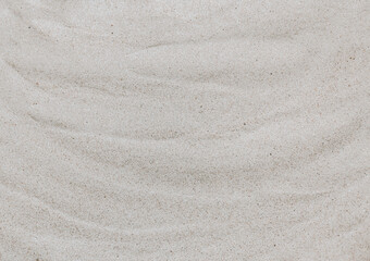 Fototapeta na wymiar Wavy white sand, top view. Sandy beach background. Abstract sand texture close up. Summer concept.