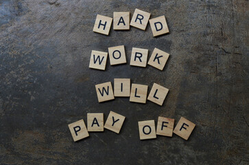 hard work will pay off text on wooden square, inspiration and motivation quotes
