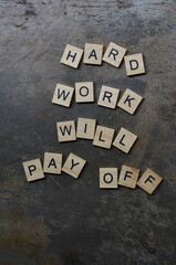hard work will pay off text on wooden square, inspiration and motivation quotes